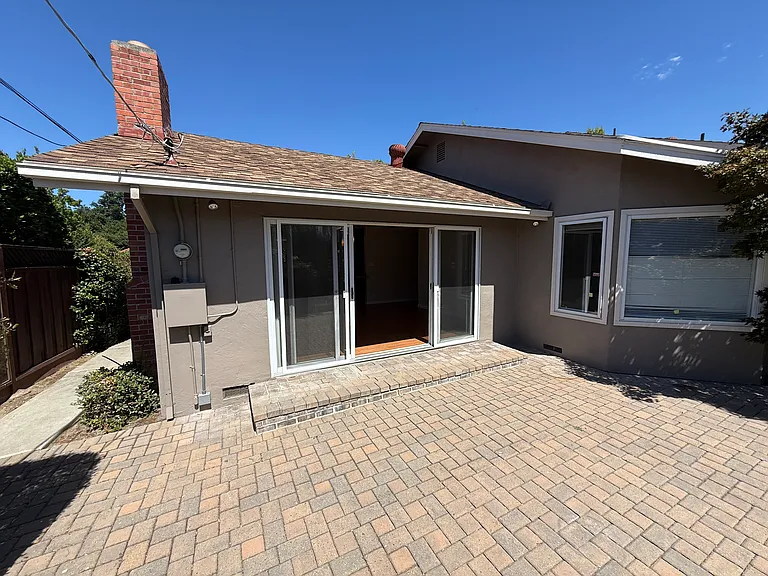 View of backyard entrance to family living room. View of large windows located in 3rd room