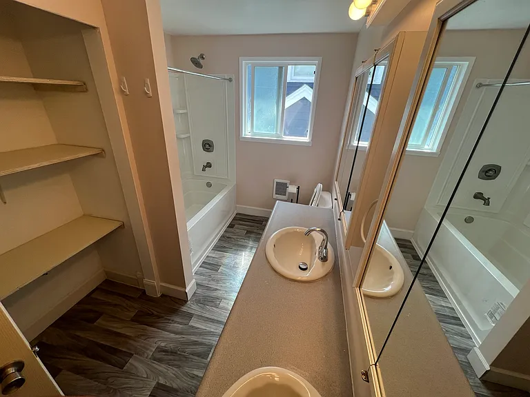 Full bathroom with shower, tub, and 2 sinks
