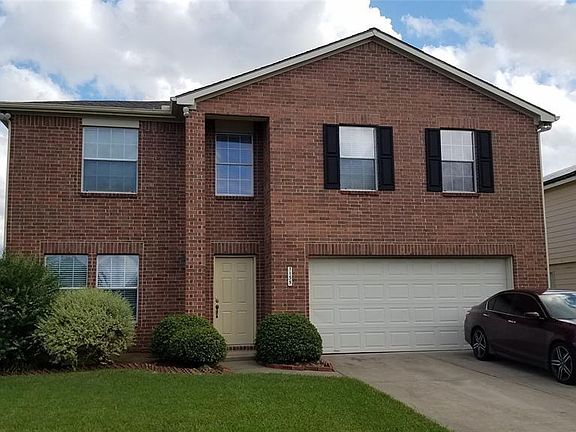 Doublewide driveway with a two car garage