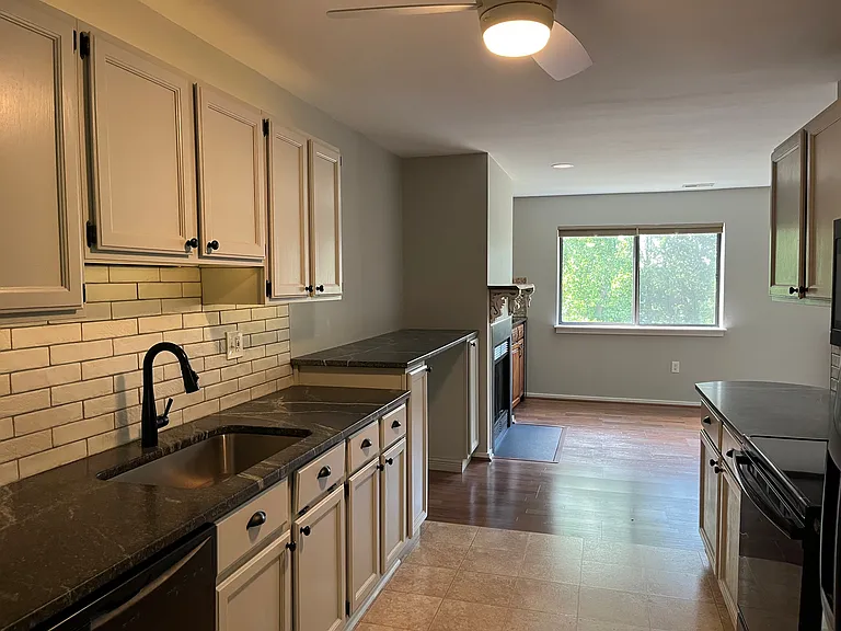 Updated kitchen with recently painted cabinetry, counter, faucet, and kitchen appliances