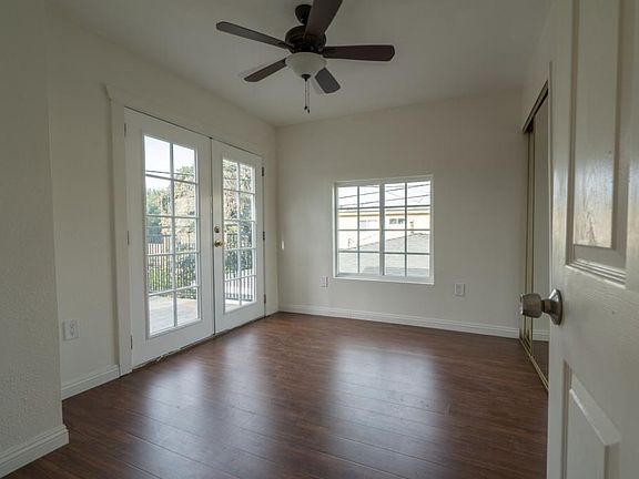 Bedroom with French doors leading to large balcony