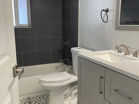 all new modern bathroom with designer tile and fixtures