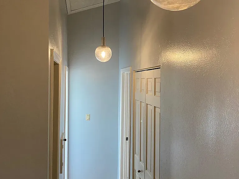 Welcoming entryway with soaring ceilings and abundant natural light creating an impressive first impression.