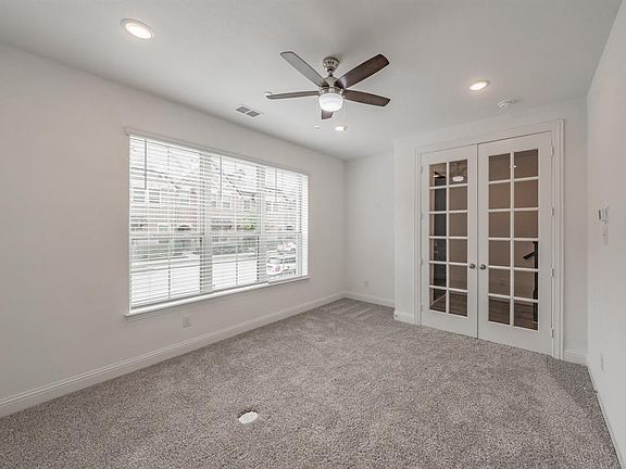 Empty room with french doors, ceiling fan, carpet, and recessed lighting