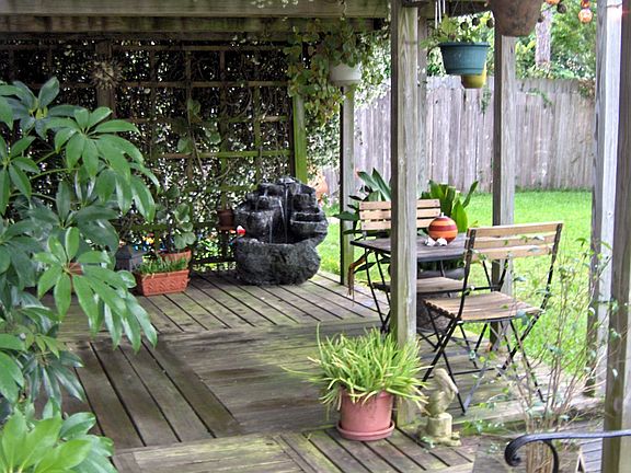 Arbor covered deck with Lava rock fountain