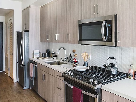 Gally Kitchens with gorgeous cabinetry, tile backsplash and quartz countertops.