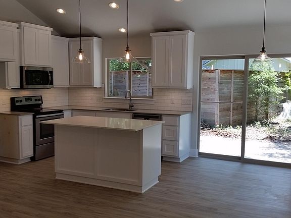 Island kitchen, SS appliances, solid surface floors throughout