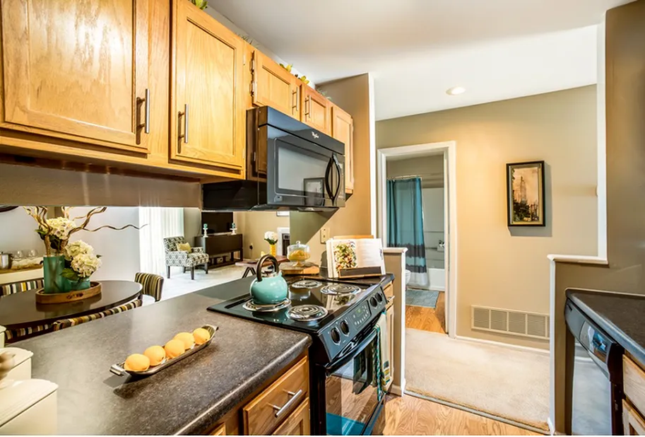 Galley Style Kitchen with Upgraded Appliances - Westchase Apartments