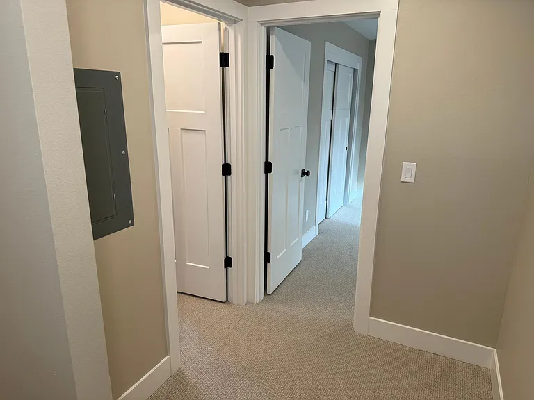Spacious hallway and the bedroom entries.