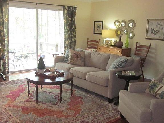 Living Room with hardwood floors, fireplace, built ins and sliding glass door to deck.