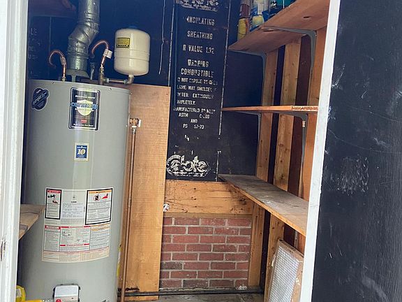 Outdoor storage with hot water heater. Also there's space under the house for outdoor equipment