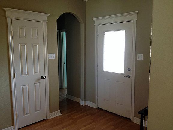 Entrance foyer with arch through to two bedrooms and second bathroom.