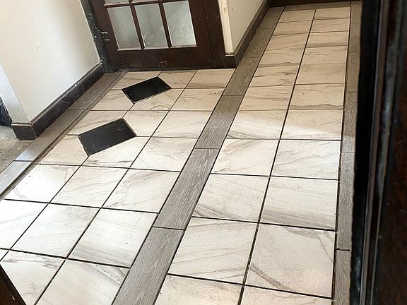 Entrance at top of stairs. View from BR. Bath to right. Kitchen to right at end. LR, DR, BR to left through archway