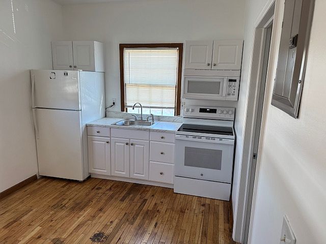 Kitchen White cabinets, countertop and appliances.