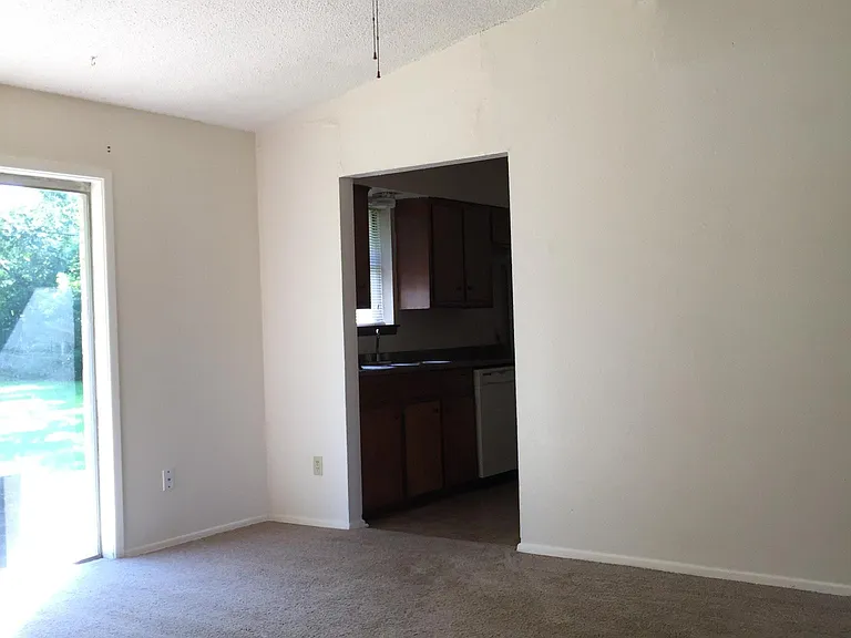 Den with cathedral ceiling ,Patio door Has new laminate flooring, 
Not carpet.
