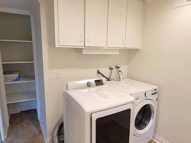 Laundry room with storage shelves.