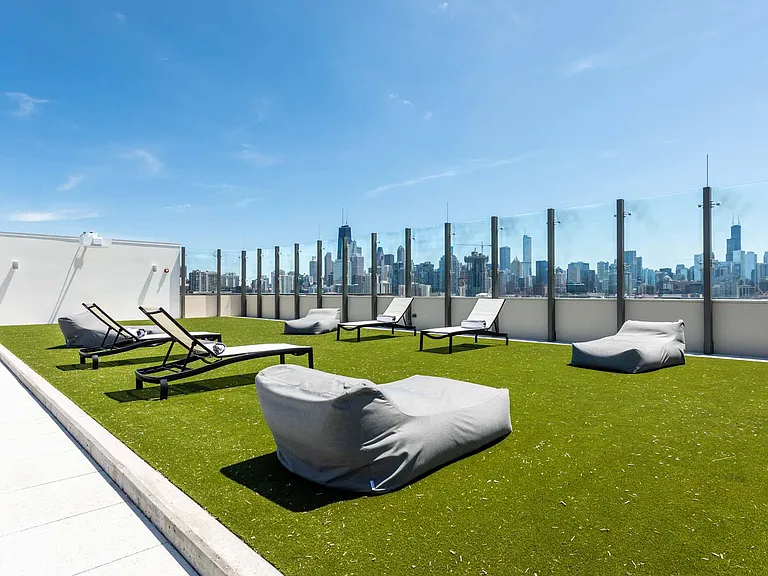 Chill out in the rooftop beanbag area, surrounded by lush grass, offering a laid-back space to enjoy the breeze and take in the view.