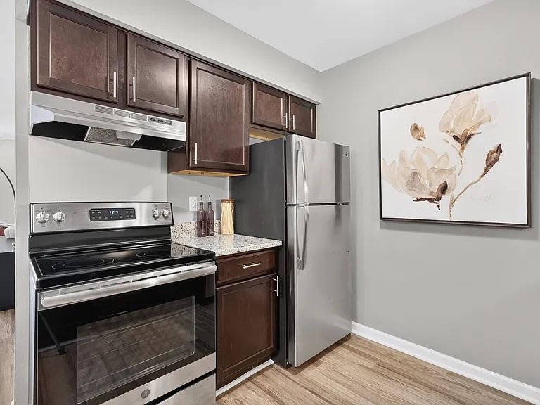Spacious Kitchen with stainless steel appliances and dark cabinets at Lakeside Village Apartments Clinton Township, MI