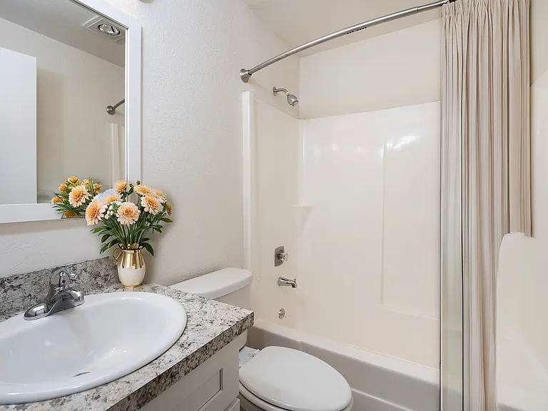 Experience elegance in this beautifully designed bathroom, featuring a sleek countertop and charming floral decor. Experience elegance in this beautifully designed bathroom, featuring a sleek countertop and charming floral decor.