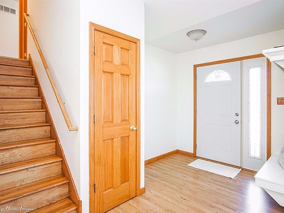 FOYER WITH COAT CLOSET AND SITTING BENCH