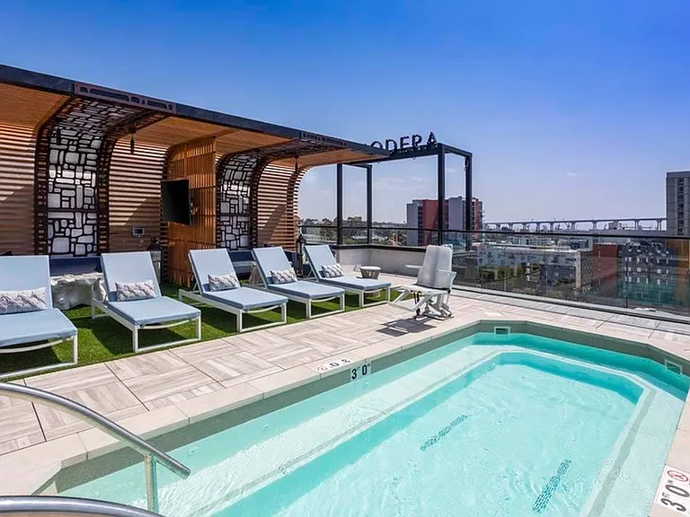 Look out at the city and bay from the rooftop pool deck at Modera San Diego