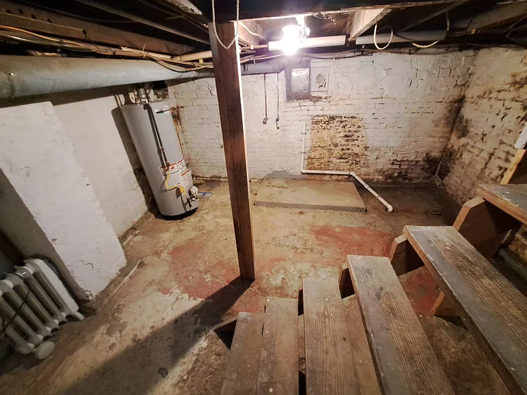 Half basement with laundry hookups, minimal storage.