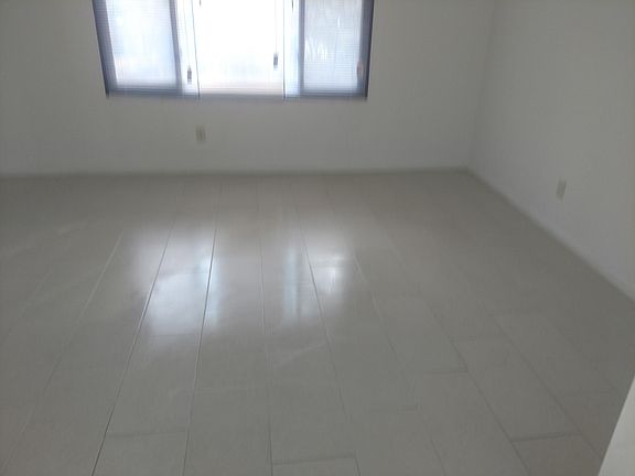 new ceramic tile in large bedroom (both bedrooms are of equa