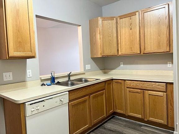 Kitchen featuring dishwasher and oak cabinets