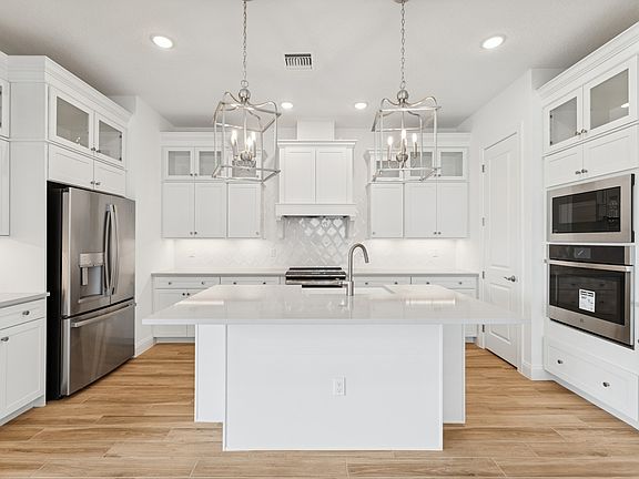 Kitchen with stacked glass-front upper cabinets