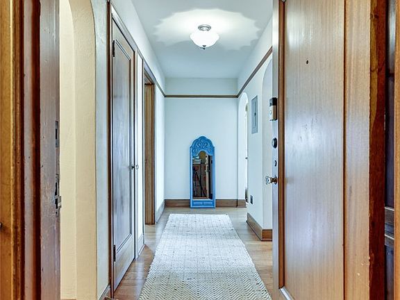 Entering #307... real, century-old hardwoods! Arched doorways, elaborate millwork and vintage hardware.  A visual, architectural treat!