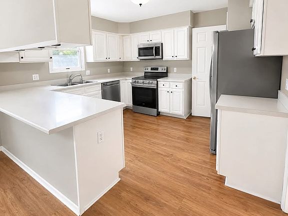 Full kitchen with brand new stainless steel appliances on main level.