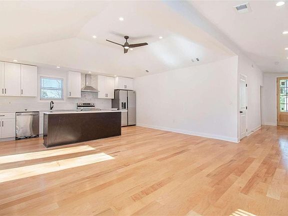 open floorplan with modern kitchen and acess to patio