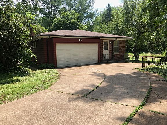 Driveway with 2 car garage with 6' clearance on the door.