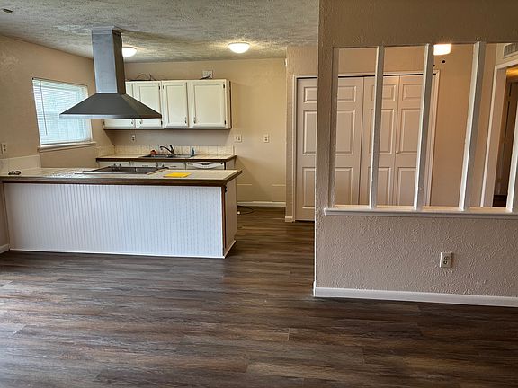Living room view into dining room and open kitchen