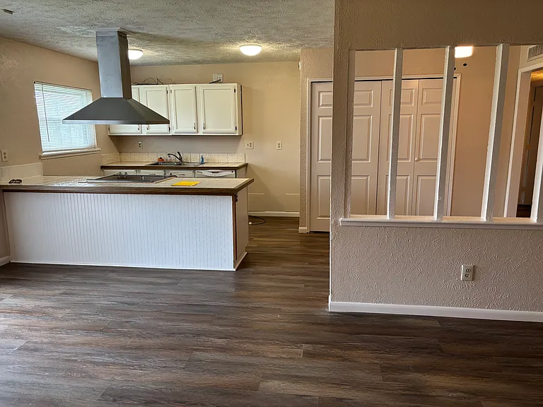 Living room view into dining room and open kitchen