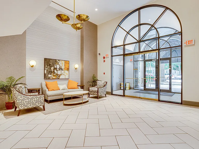 Bright and sophisticated building lobby, featuring contemporary seating and an inviting atmosphere