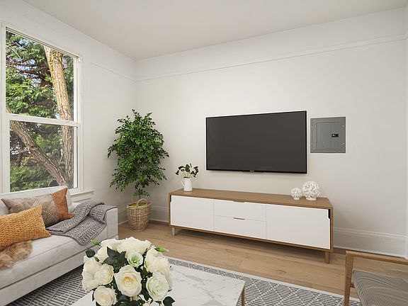 Living room with big windows, new vinyl wood-like flooring.