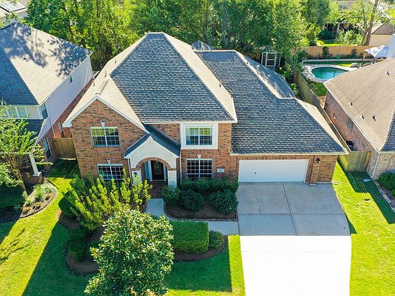 This amazing aerial view of the front of the home provides a great view of how spacious this home is! The doublewide driveway expands at the garage door allowing more room between cars & the garage door opener was replaced in 2021!
