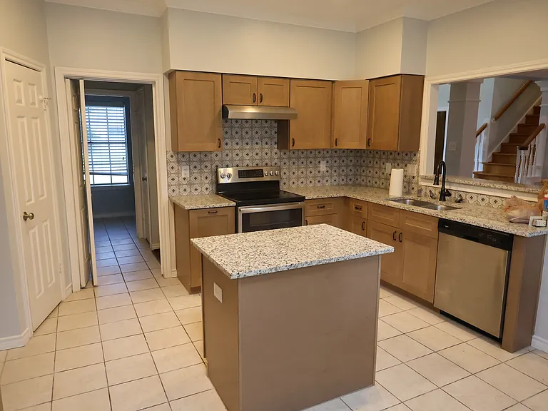 Modernized kitchen with an island for cutting and chopping. Plenty of cabinet space. Large walk-in pantry.