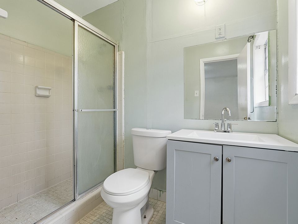 The lower level features a separate studio-style suite with its own full bathroom, kitchen, and private entrance ideal for a guest suite, home office, or bonus living space.