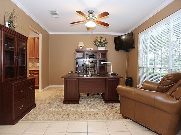 This room currently used as a study could easily convert back to a dining room.