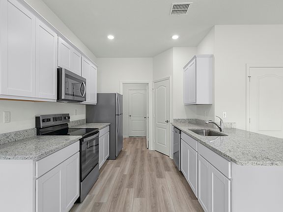 A chef-ready kitchen with granite countertops and stainless steel appliances