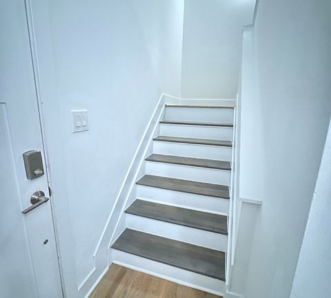 The stairway to the left takes you upstairs to the living room, dining room, kitchen, half bath, and terrace