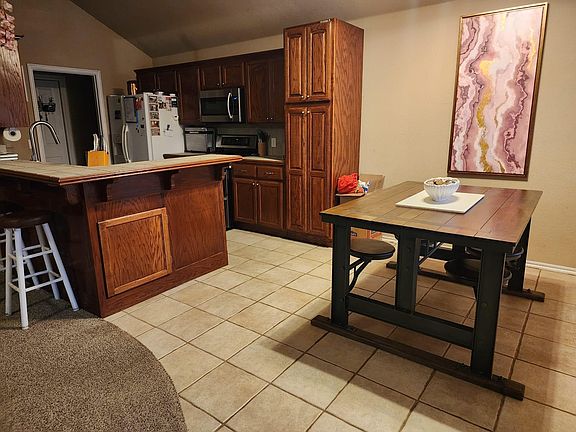 Dining room equipped with table with 4 swivel seats.