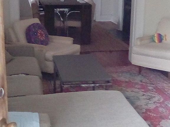 Living room, looking from the front door. The window unit heats and cools, but there's also a working floor furnace.