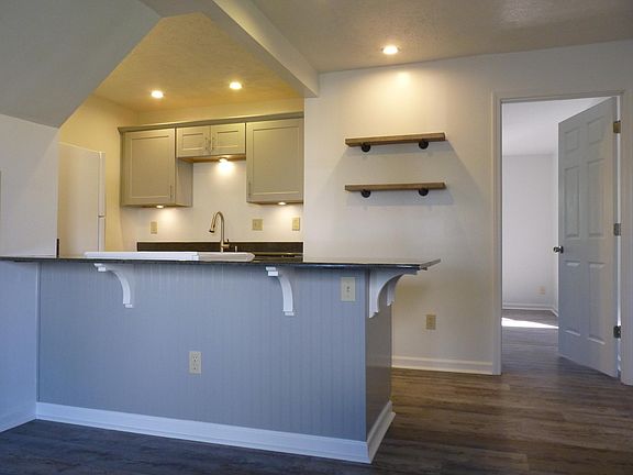 Floating shelving and a 50" TV mount make this a modern space to call home!