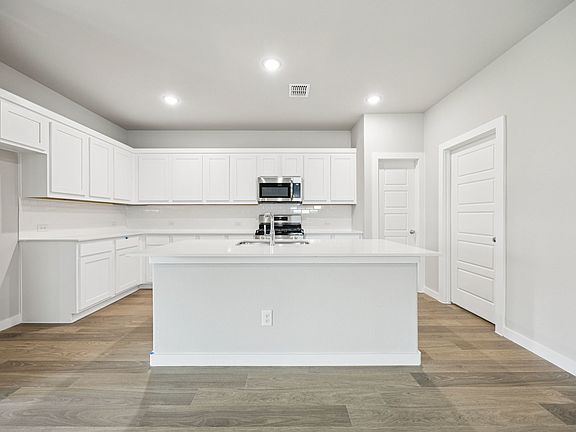 Kitchen in the Hayden home plan by Trophy Signature Homes - REPRESENTATIVE PHOTO