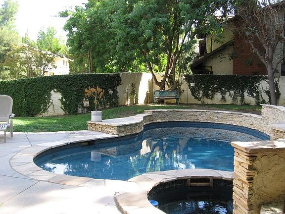 Magnificent newer blue btm pool & spa, lots of grassy areas!