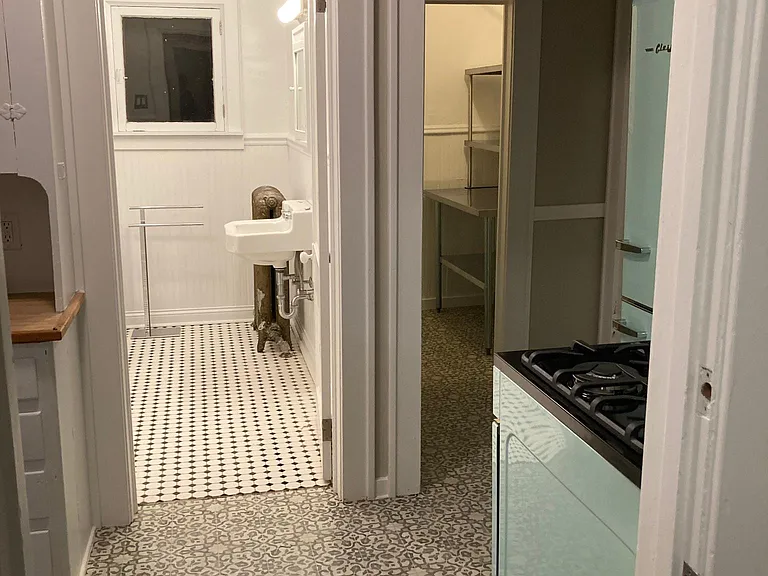 Kithchen view into Bathroom and Pantry storage
