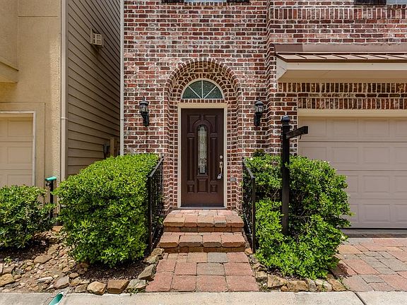 An arched, covered front porch and handsome door with leaded glass welcomes you in to this beautiful home.